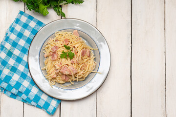 creamy spaghetti pasta with ham on white background