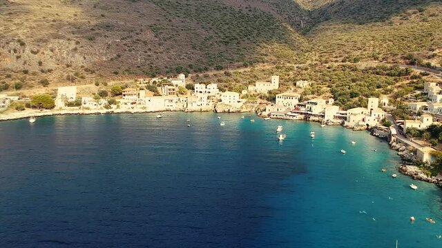 Scenic aerial view from the picturesque seaside village Limeni at sunset. Traditional houses and colorful stoned buildings and luxurious hotels in Limeni, Mani area, Laconia, Greece, Europe