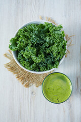 kale juice in a glass on white surface