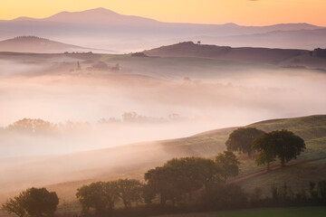 Fototapeta premium fog over the valley, foggy colorful morning, Tuscany, Italy