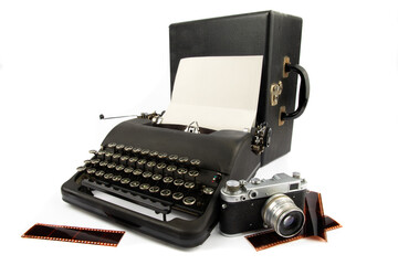 an old black portable typewriter with an old 35 mm film camera and film strips suggesting a 1950s...