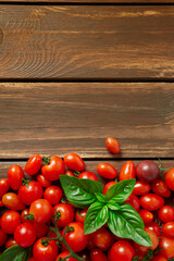 Fototapeta na wymiar variety of miniature tomatoes on dark wooden surface