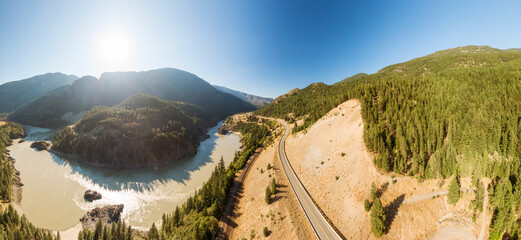 Beautiful Panoramic View of Canadian Nature and a Scenic Road, Trans-Canada Hwy, during sunny summer day. Aerial Drone Shot. Near Hells Gate, BC, Canada.