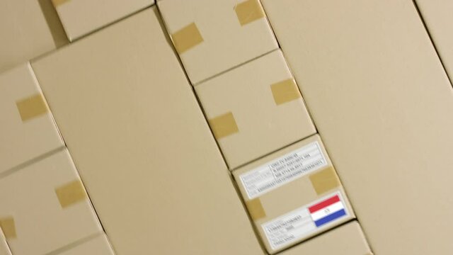 Parcel with MADE IN PARAGUAY text and flag, production and transportation concept