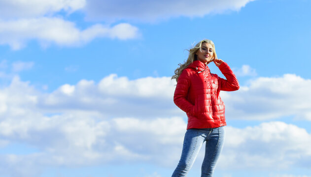 Wind of changes. Female psychology. Woman fashion model outdoors. Woman enjoy cool weather. Matching style and class with luxury and comfort. Fashion outfit. Windy day. Girl red jacket cloudy sky