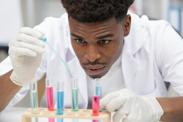 handsome male lab technician concentrating doing medical research
