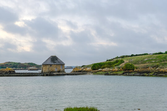 Ile de Brehat, France - August 27, 2019: Moulin a Maree du Birlot or Birlot Tide Mill located on the Kerpont Channel on Island of Brehat in Brittany