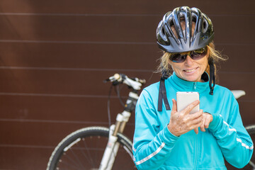 girl with bicycle helmet and mobile phone