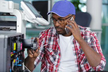 a man is fixing a printer