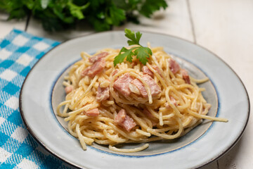 creamy spaghetti pasta with ham on white background