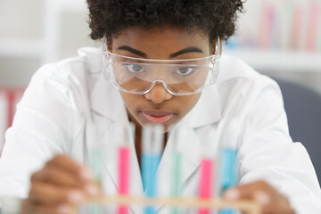 woman in the lab looking at pipettes