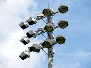 closeup of a set of 12 high intensity stadium lights on a pole