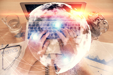 Double exposure of man's hands typing over computer keyboard and business theme hologram drawing. Top view. Financial markets concept.