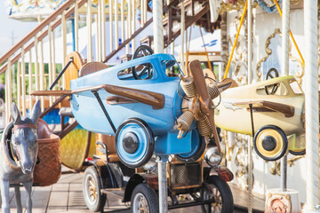 Fototapeta premium toy plane on a beautiful carousel in an amusement park 