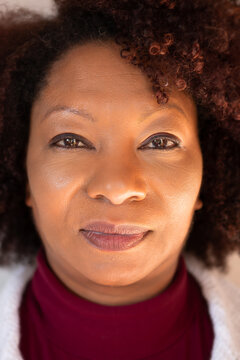 Close up portrait of  brazilian african american woman with serious expression looking at camera .