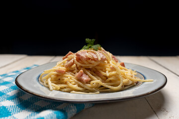 creamy spaghetti pasta with ham on white background