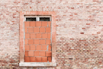 Fototapeta na wymiar View of old building, bricked up window