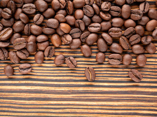 Coffee beans on an old wooden grunge background with space for text