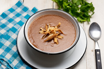Mexican cream of bean soup on white background
