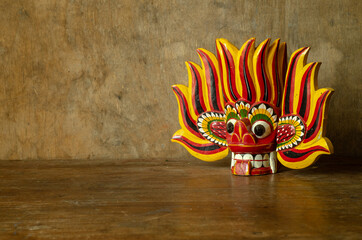 Red wooden mask on a retro background.
