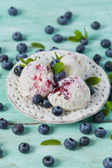 blueberry ice cream on turquoise surface