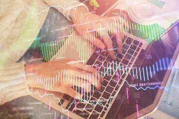 Double exposure of woman hands typing on computer and forex chart hologram drawing. Stock market invest concept.