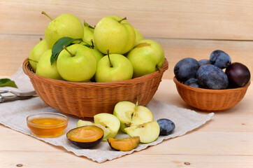 beautiful still life of a fruit basket apples and plums