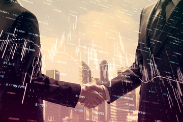 Double exposure of forex graph hologram and handshake of two men. Stock market concept.