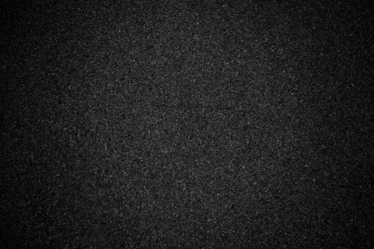 Black asphalt background texture with vignete. Abstract black background