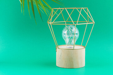 Fototapeta na wymiar Modern geometric lamp with copper wire lampshade. Metal frame of the lamp.