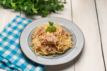 creamy spaghetti pasta with ham on white background