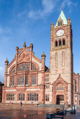 Fototapeta premium Façade of Guildhall in Derry / Londonderry, Northern Ireland, built in the 19th century with red bricks and the clock tower, meeting place of the local city council.