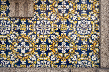Traditional old tiles wall on the street Portuguese painted tin-glazed, azulejos ceramic tilework. Porto, Portugal.