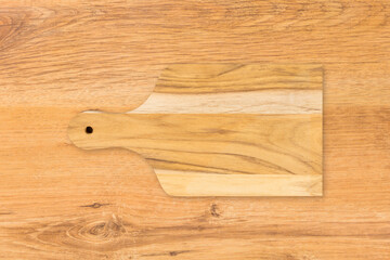 Wooden cutting kitchen Board, isolated on wooden table background. Top view