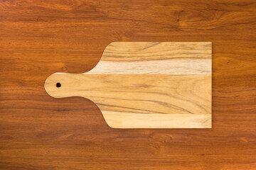 Wooden cutting kitchen Board, isolated on wooden table background. Top view