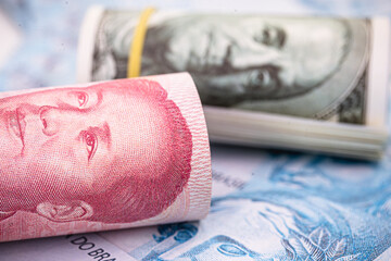 banknotes of 100 US dollars and 100 Chinese yuan Renminbi, concept of global economy