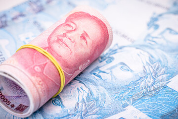 money from china and brazil, banknotes of one hundred reais and banknotes of 100 yuan, or Renminbi. Brazil and china market concept.