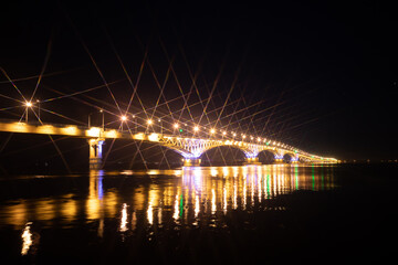 The bridge across the river glows at night