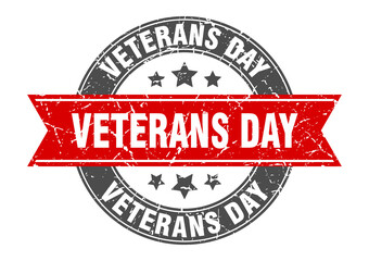 Obraz premium veterans day round stamp with ribbon. label sign