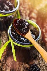 Jar of Blackberry Jam Preserves on Old Wooden Background. Selective focus.