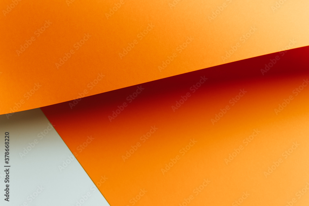Fototapete Orange and white flat lay background with sharp layers and shadows with copy space