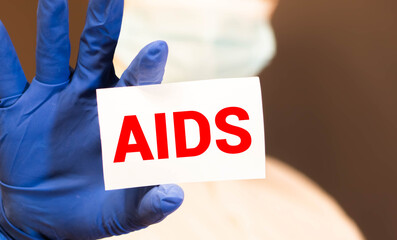 Page with AIDS Acquired Immune Deficiency Syndrome on the table with stethoscope, medical concept