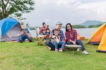 Foto op Plexiglas asian family travel and camping in forest, they sitting and relax at lakeside, they feeling happy in family time, adventure and travel © jokekung