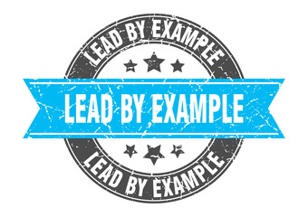 Obraz premium lead by example round stamp with ribbon. label sign