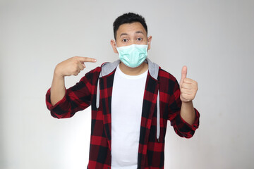 Asian man wearing facial mask, new normal during covid-19 coronavirus pandemic situation