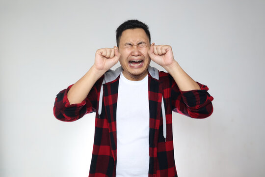 Funny Asian man crying hard, sad depression frustration hopeless expression