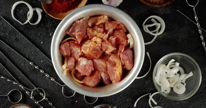 Raw kebab of pork in the bowl slowly rotates. 