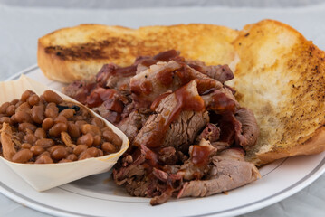 BBQ meal of tri-tip, baked beans, and butter toasted bread will taste as delicious as it looks.