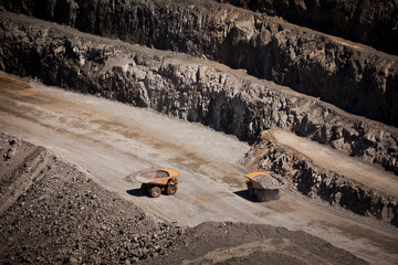 Yellow trucks inside an open cast mine in New South Wales, Australia. Barrick Cowal Gold Mine.