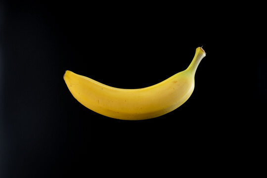 banana fruit sitting on a black background